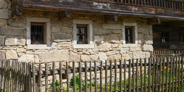 Wooden window with glazing and partially weathered in rustic homes