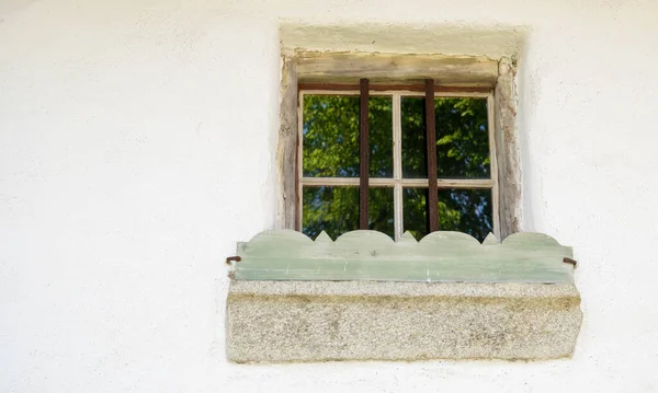 Wooden window with glazing and partially weathered in rustic homes