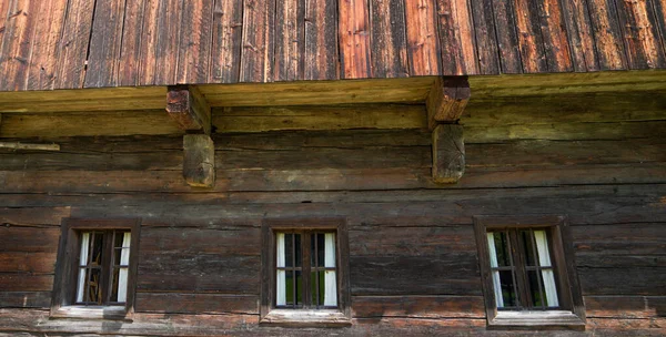 Wooden window with glazing and partially weathered in rustic homes