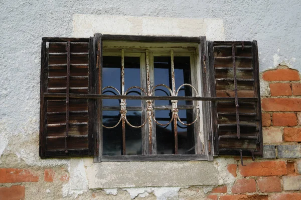 Wooden window with glazing and partially weathered in rustic homes