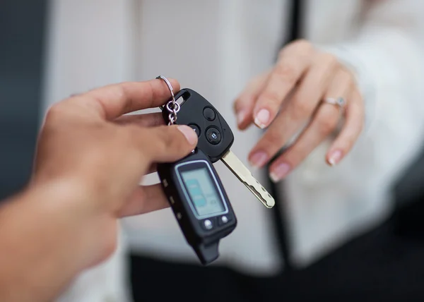 Male hand giving car key to female hand. — Stock Photo, Image