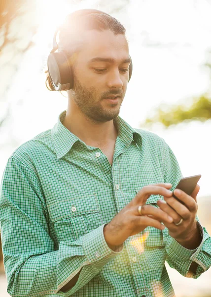Guy listening to player in park — Stock Photo, Image