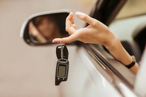 Fille joyeuse tenant les clés de voiture de la fenêtre — Photo