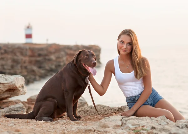 Retrato de una mujer con su hermoso perro sentado al aire libre . — Foto de Stock