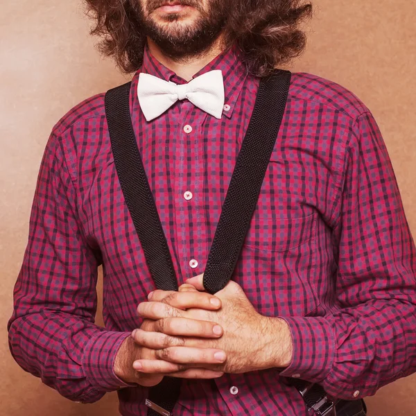 Hipster guy 's clothes in a cage , suspenders and white butterfl — Stock Photo, Image