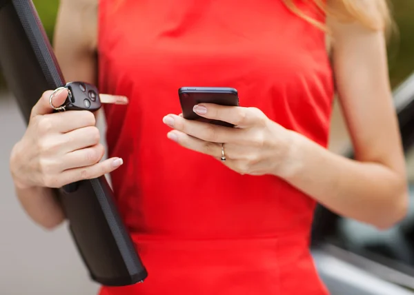 Jonge mooie vrouw schrijft een sms naar uw mobiele telefoon. — Stockfoto