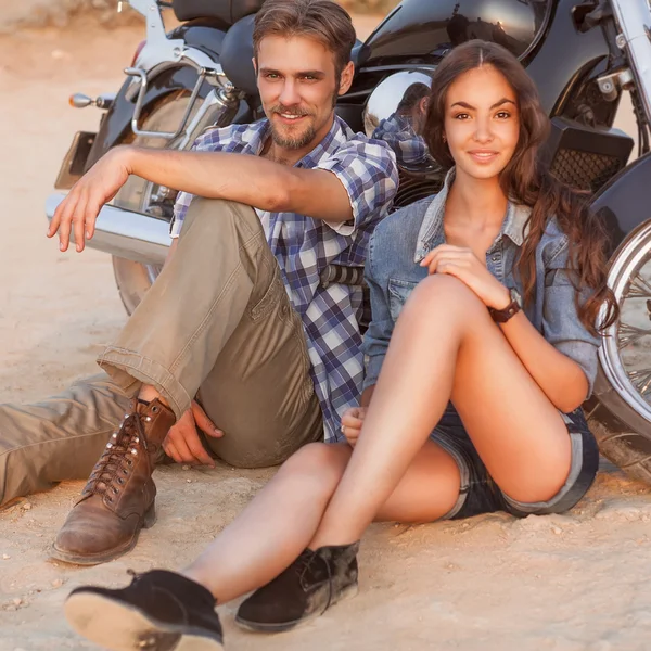 Two people and bike - fashion woman and man sitting by motorbike — Stock Photo, Image