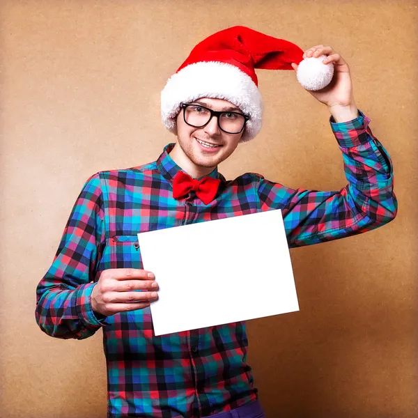 Hipster Babbo Natale punta in bianco segno bianco con sorriso — Foto Stock