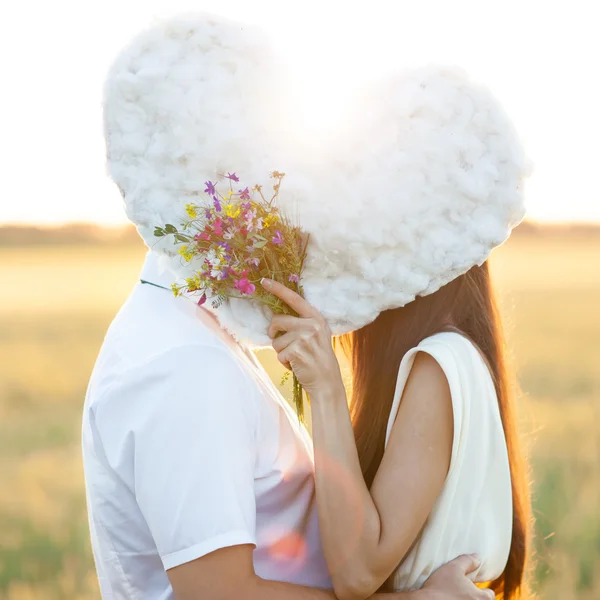 Young couple kissing behind — Stock Photo, Image