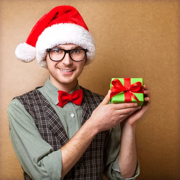 Guy holding a gift and emotionally happy Christmas — Stock Photo, Image