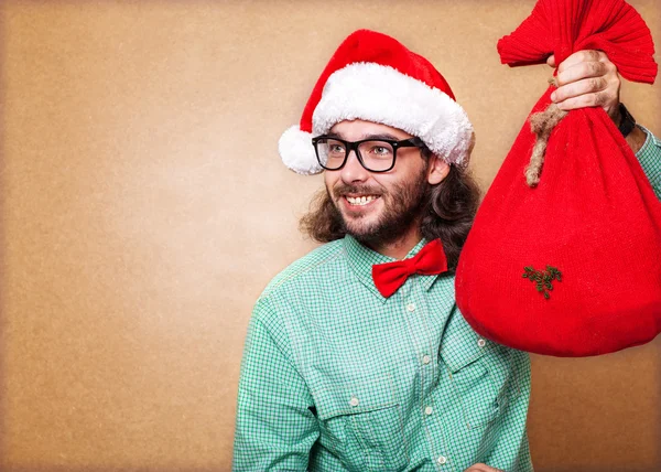 Hipster Weihnachtsmann mit der Tüte mit den Geschenken — Stockfoto