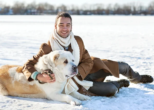 Man and central Asian shepherd walk in the park — Stock Photo, Image