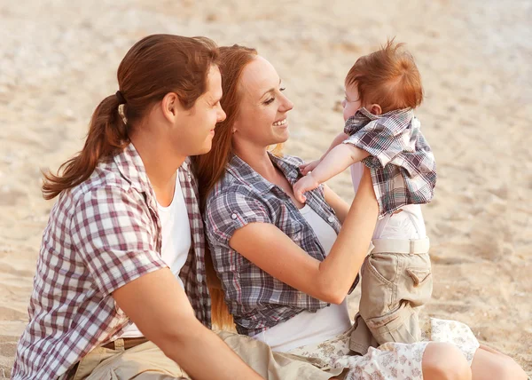 Happy mother, father and son in sunset Stock Picture