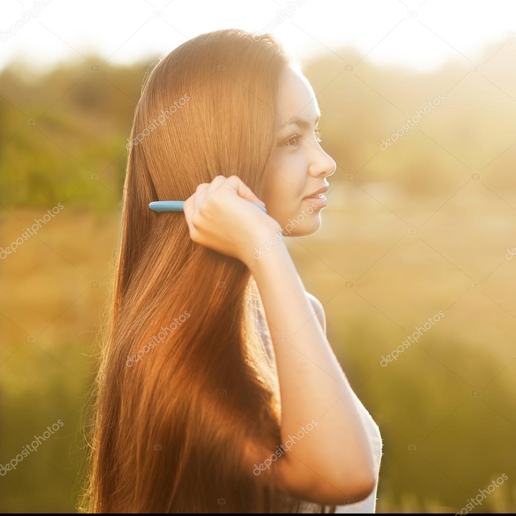 beautiful girl combs her hair