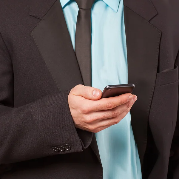 Close up of a man using mobile smarphone — стоковое фото