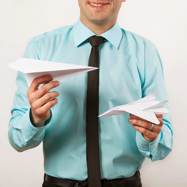 Young male businessman holding origami airplanes, studio — Stock Photo, Image