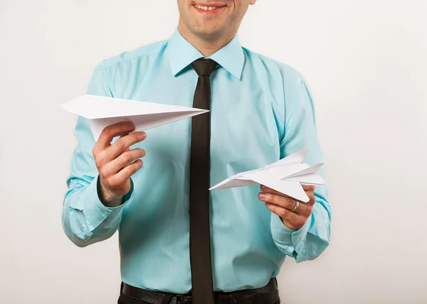 Young male businessman holding origami airplanes, studio — Stock Photo, Image
