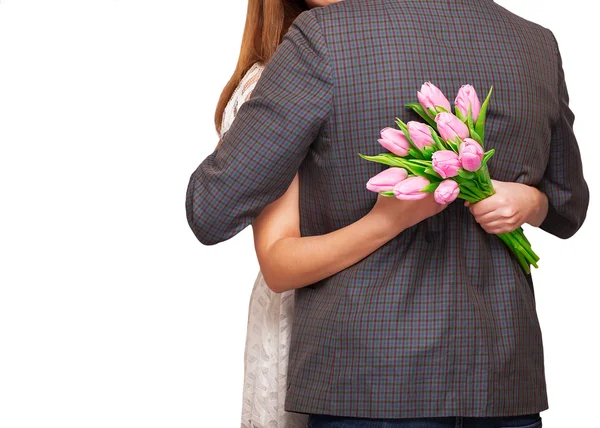 Young couple in love make a heart and hands are holding a bouque — Stock Photo, Image