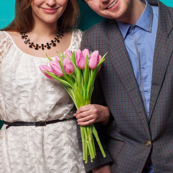 Beautiful couple in love with flowers tulips.Valentine's Day — Stock Photo, Image