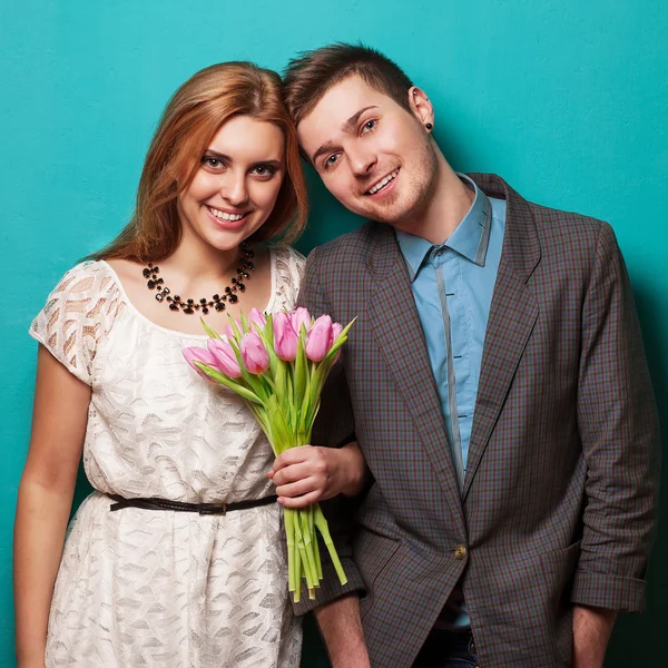 Beautiful couple in love with flowers tulips.Valentine's Day — Stock Photo, Image