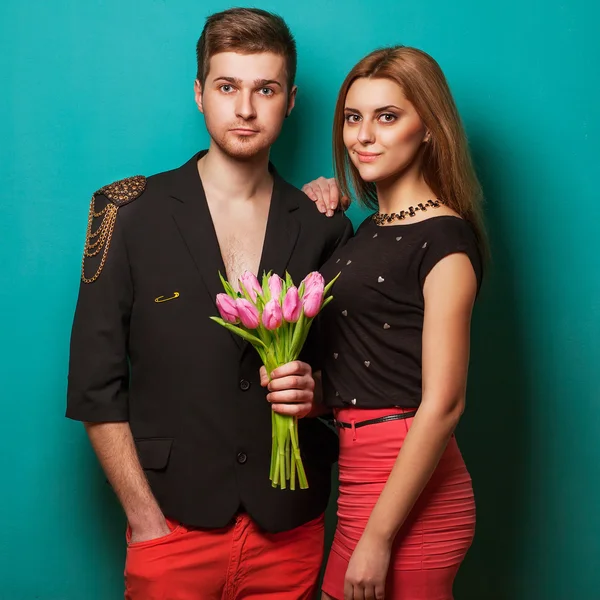 Young couple in love holding a bouquet of tulips.