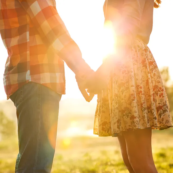 Young couple in love walking in the autumn park holding hands — Stock Photo, Image