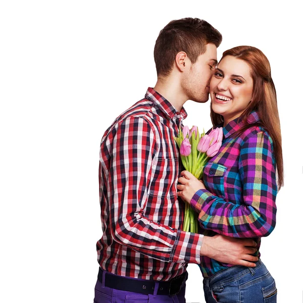 Pareja joven enamorada sosteniendo un ramo de tulipanes . — Foto de Stock