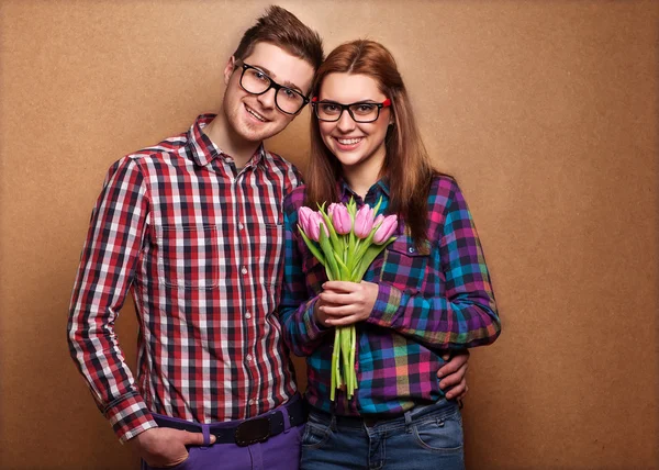 Young couple in love holding a bouquet of tulips. — Stock Photo, Image