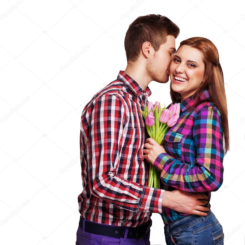Young couple in love holding a bouquet of tulips.