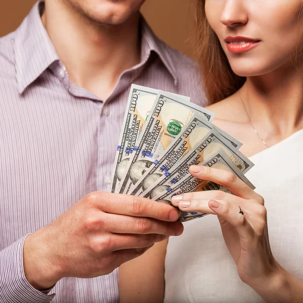 Fashion beautiful couple in love holding money the family budget — Stock Photo, Image