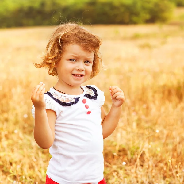 Little girl running on meadow with sunset — Stock Photo, Image