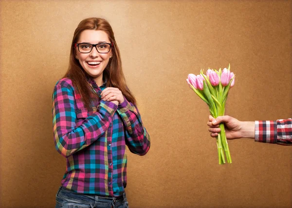 Girl wearing hipster surprised donation of a bouquet of flowers — Stock Photo, Image