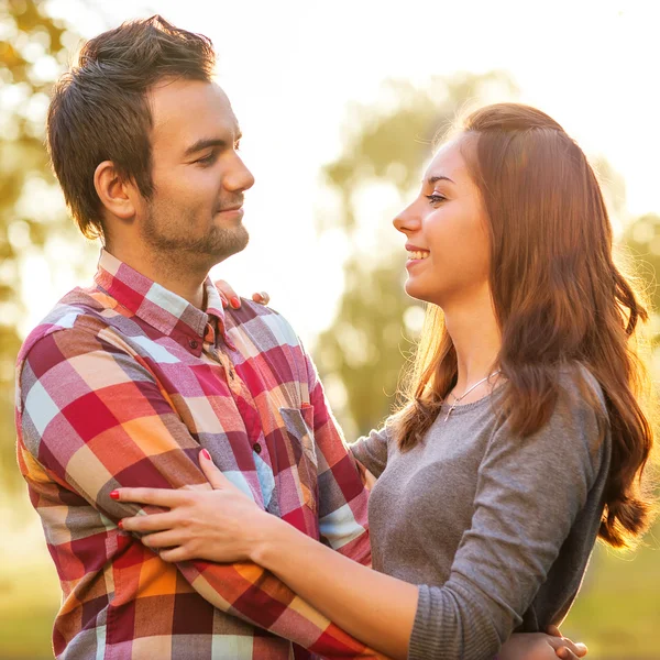 Young couple in love walking in the autumn park near the river. Stock Photo