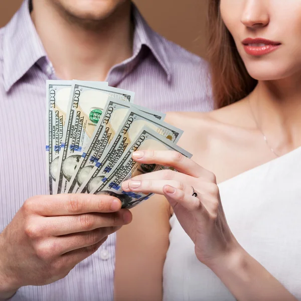 Loving couple are holding a large sum of money. — Stock Photo, Image