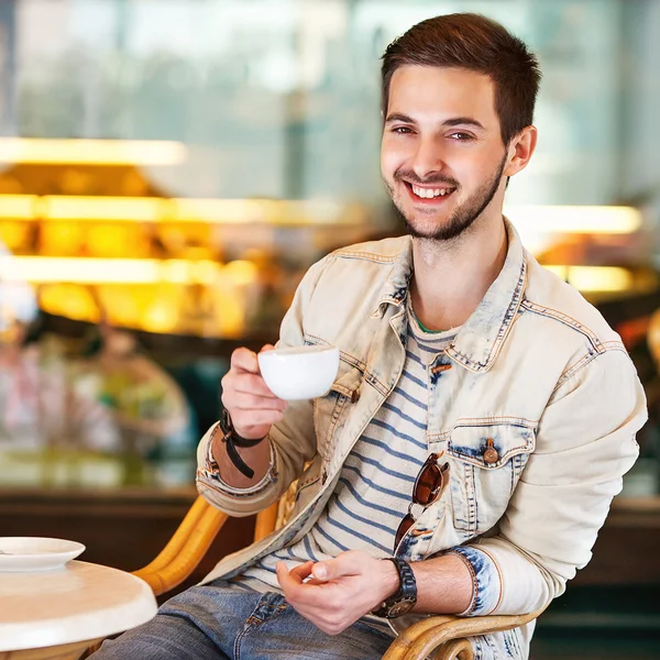 Joven hombre de la moda con barba bebiendo café expreso en la ciudad —  Fotos de Stock