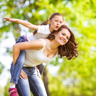 Mother and daughter in park. Mother Day. clipart