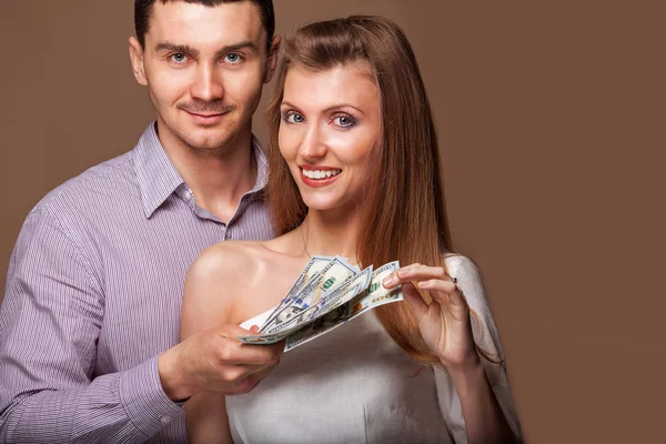 Fashion beautiful couple in love holding money — Stock Photo, Image