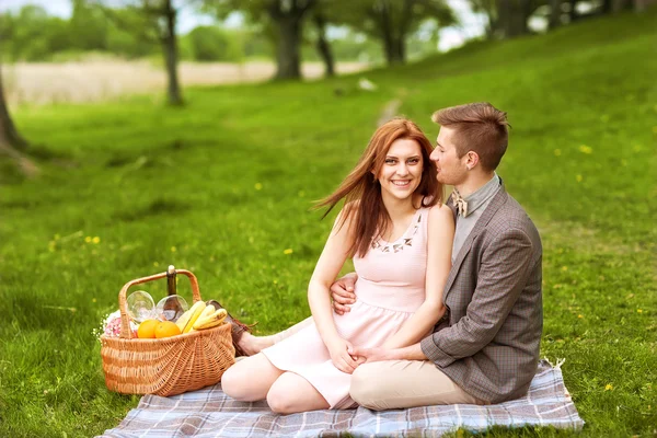 Couple in love in sitting near the river, picnic — Stock Photo, Image
