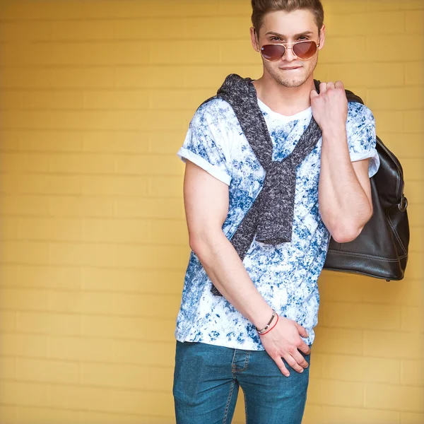 Sexy fashion man with beard dressed casual smiling brick wall — Stock Photo, Image