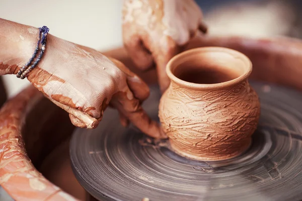 Hands working on pottery wheel , retro style toned — Stock Photo, Image