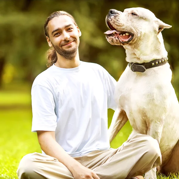 Man and Dog Argentino walk in the park. — Stock Photo, Image