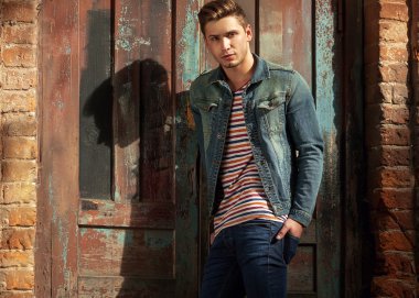hippi tarzı adam. moda ahşap kapının yanında duran adam