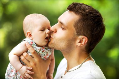 dad and baby daughter playing in the park in love clipart