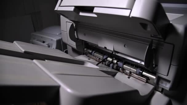 Close-up of an industrial printer output mechanism work. Paper exit after printing — Stock Video