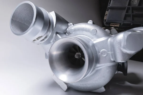 New metal turbocharger. Exhaust gas blower. Parts background — Stockfoto