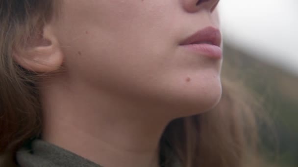 Närbild av den nedre delen av ansiktet på en ung kaukasisk kvinna i bergen. Haka flicka utomhus — Stockvideo