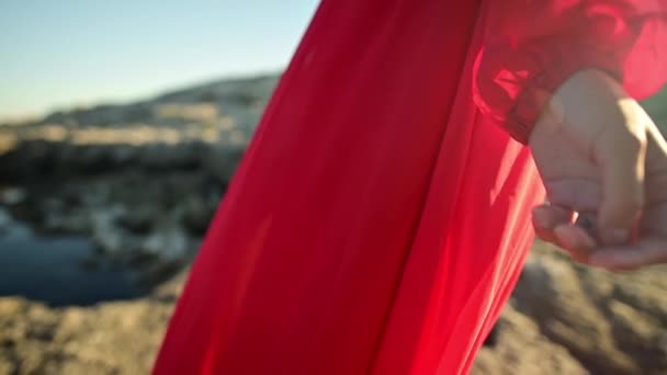 Närbild av röd klänning tyg på kaukasiska attraktiv kvinna ringar i vinden. Promenad på havet i blåsigt väder — Stockvideo