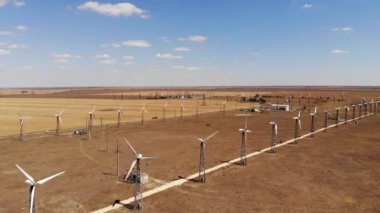 Eskimiş rüzgar türbinlerinin hava görüntüsü. Güneşli bir günde bozkırda rüzgârdan elektrik üretmek için park edin. Eski enerji üretim ekipmanları