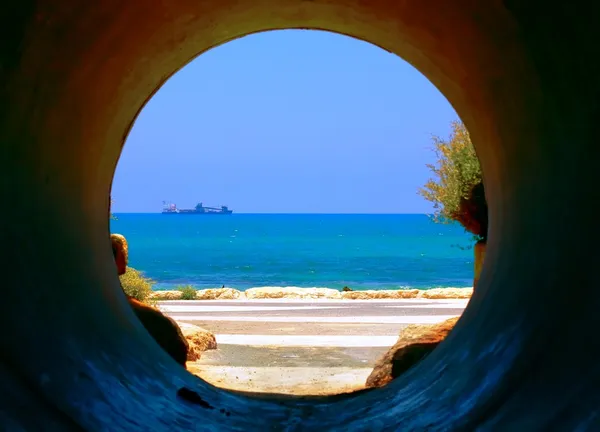 Mediterranean Sea through sewer pipe Royalty Free Stock Images