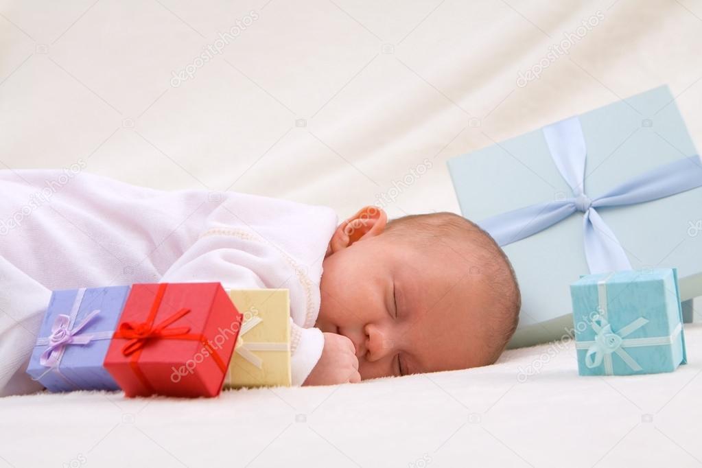 Baby Sleeping By Gift Boxes